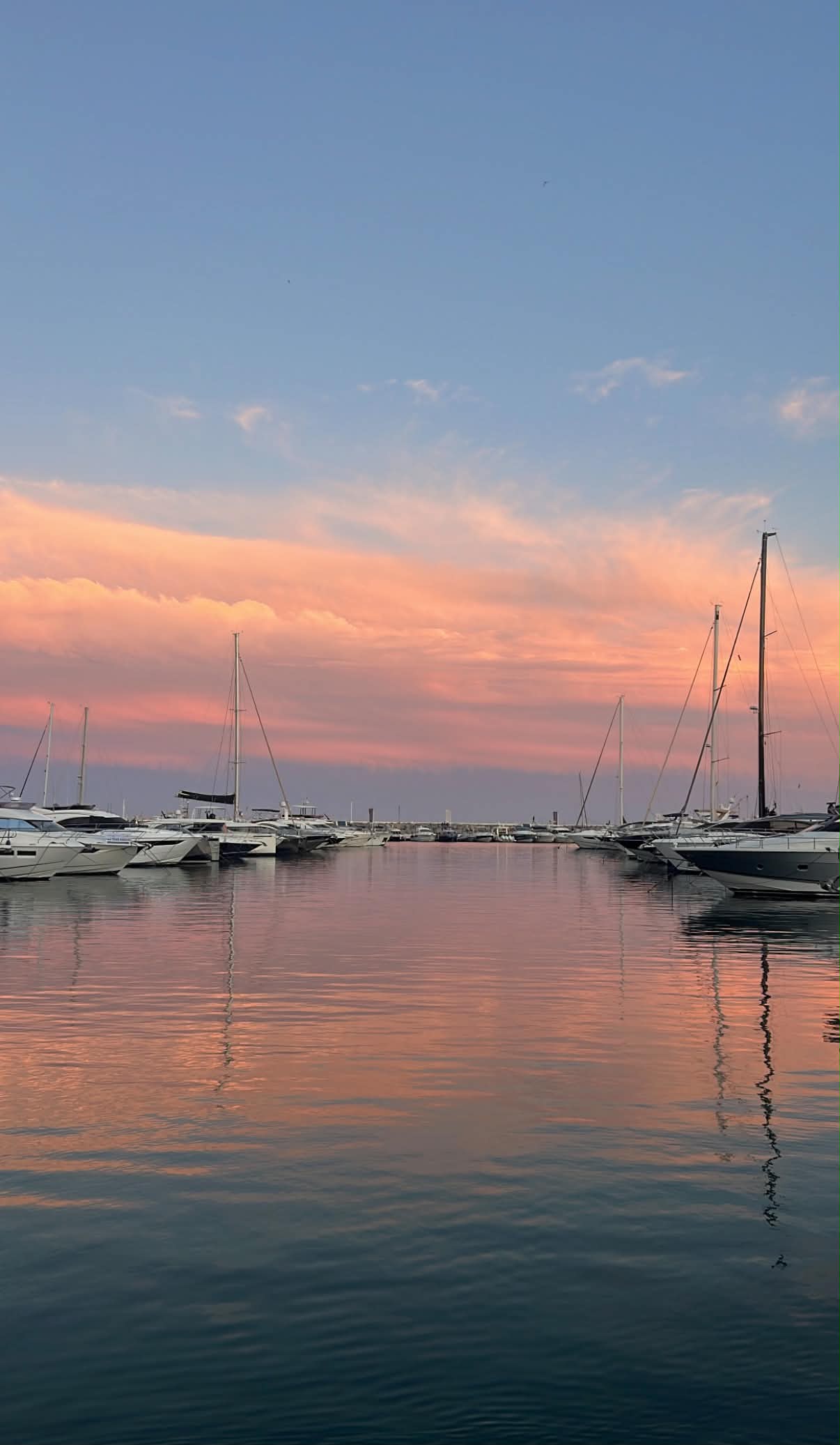 Sunset over a Marbella marina full of yachts and sailboats